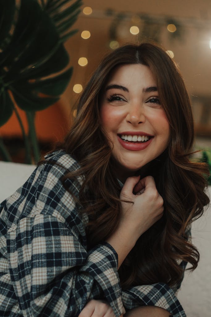 Portrait of a smiling woman indoors with cozy lighting, capturing a joyful moment in Baku.